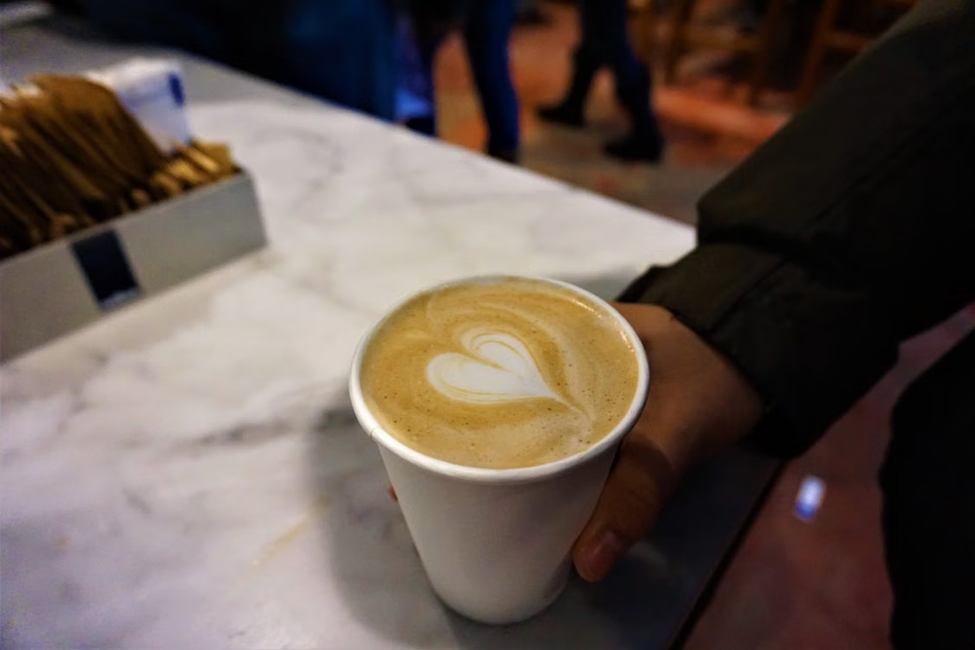 A person holding a cup of coffee.