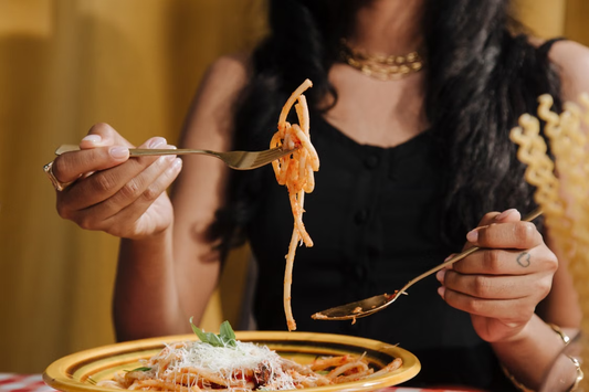 A person enjoying a flavorful pasta meal